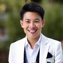 Satisfied client David Chen smiling in his custom-tailored wedding suit.
